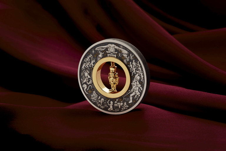 Angled Christmas Nutcracker silver coin on burgundy fabric showing the reeded edge and figurine insert