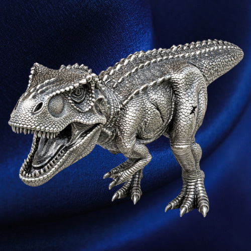 Three-quarter view, blue backdrop: Tyrannosaurus rex antiqued silver coin with open jaws, textured scales and clawed feet against a blue background.