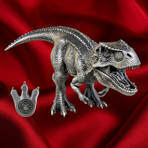 Side view, red backdrop: Tyrannosaurus rex three-dimensional silver coin beside its footprint-shaped denomination detail against a red background.