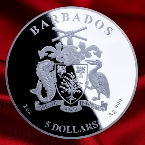 Silver coin with Barbados coat of arms and text on a red satin background.