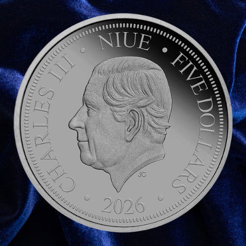 Obverse: Niue 2026 five-dollar Lucifer Bee coin showing the portrait of King Charles III on blue satin.