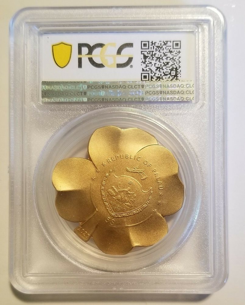 Palau coat of arms, five-dollar denomination and 2020 date on the gold-plated Gilded Fortune clover coin in its PCGS holder.