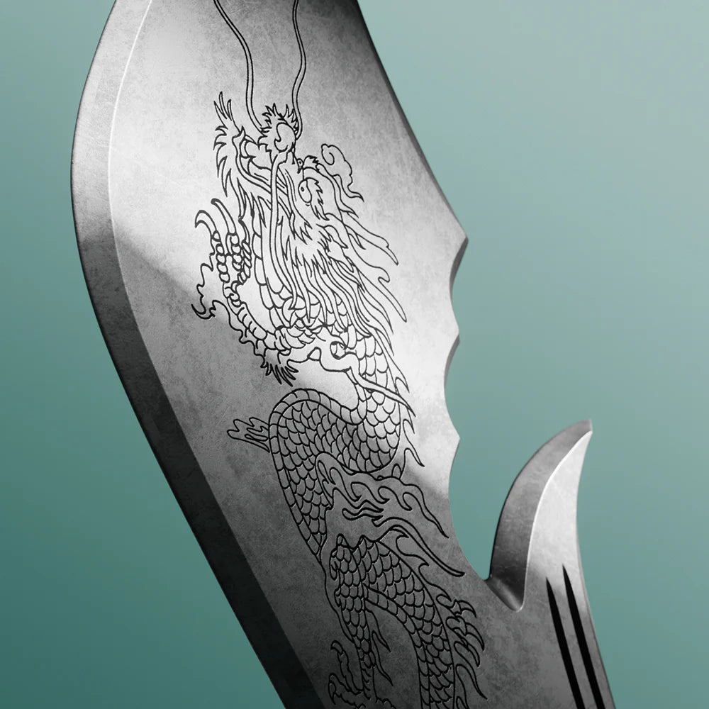 Decorative knife blade with engraved dragon design on a teal background