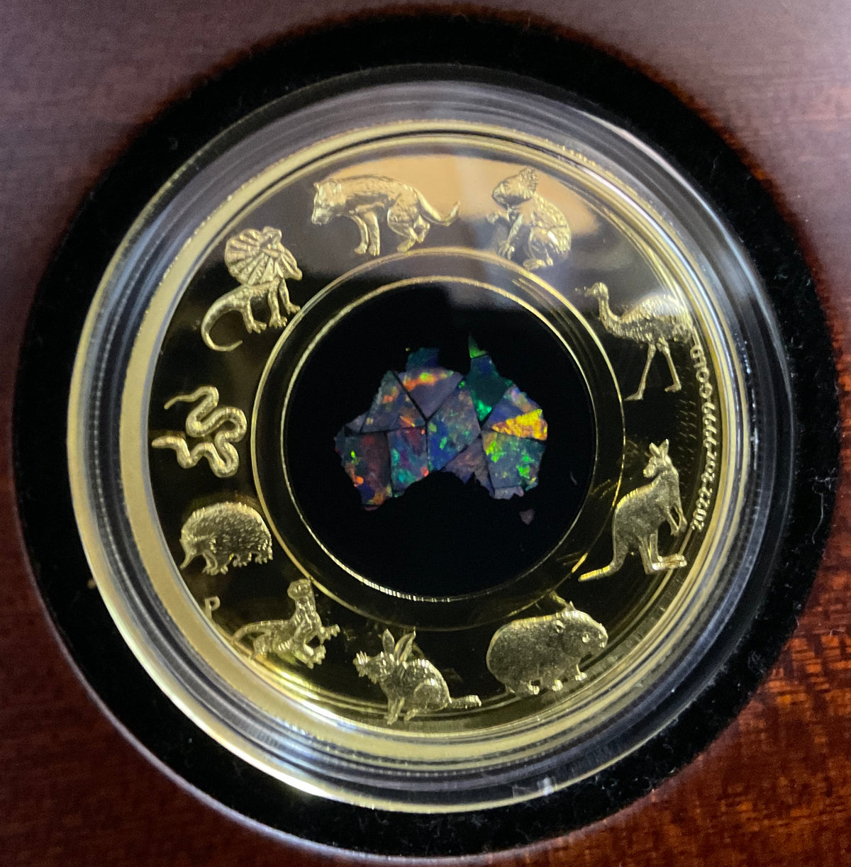Australia 2022 $200 Great Southern Land 2oz Gold Proof Opal Coin. Reverse in Wooden Caseshowing Opal in different lighting.