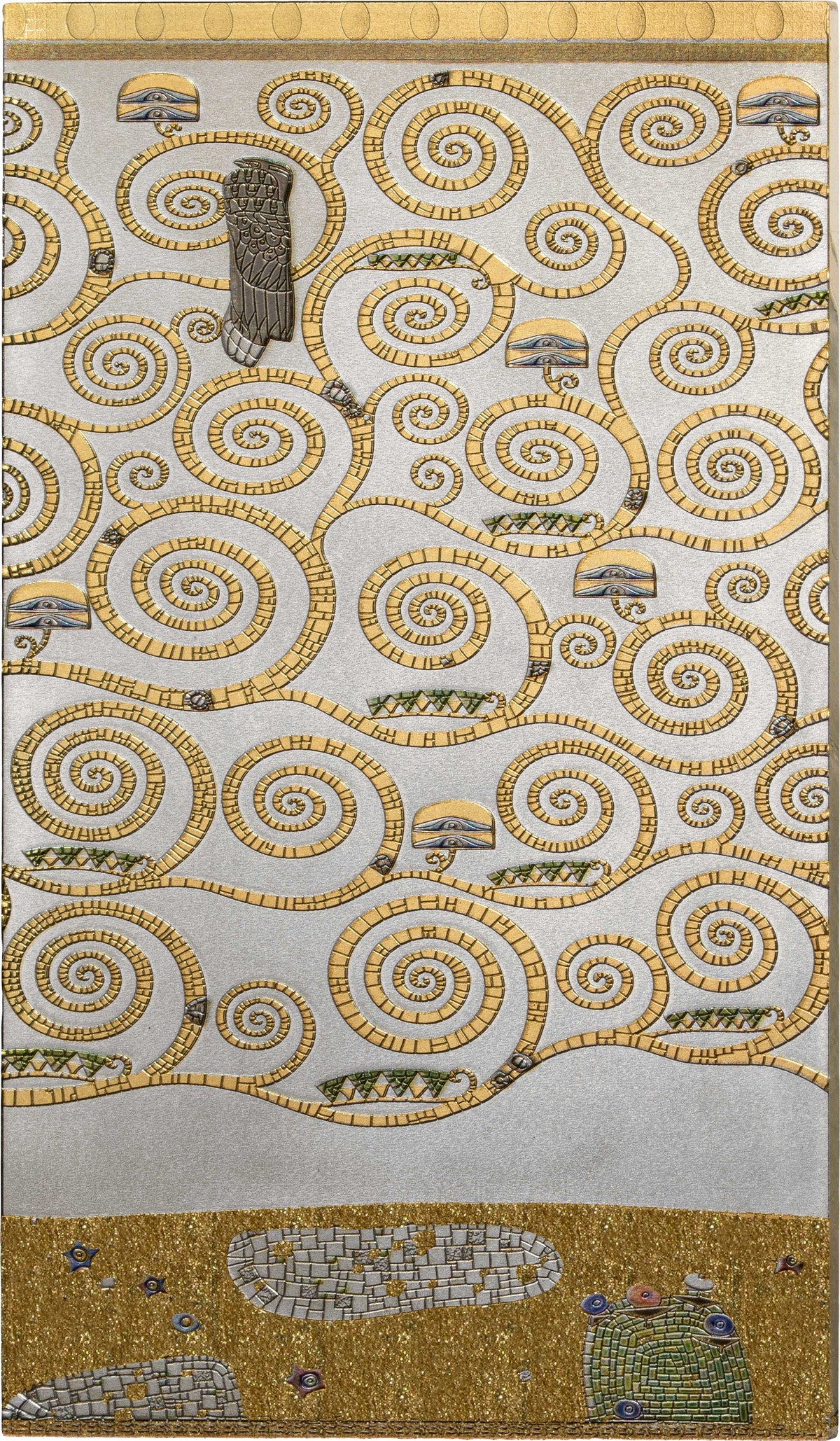 A square textile or rug featuring a decorative mosaic-style pattern of gold spirals and small landscape motifs on a light background, with a gold border at the top and bottom.