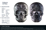 Silver skull-shaped coin with detailed design on a white background