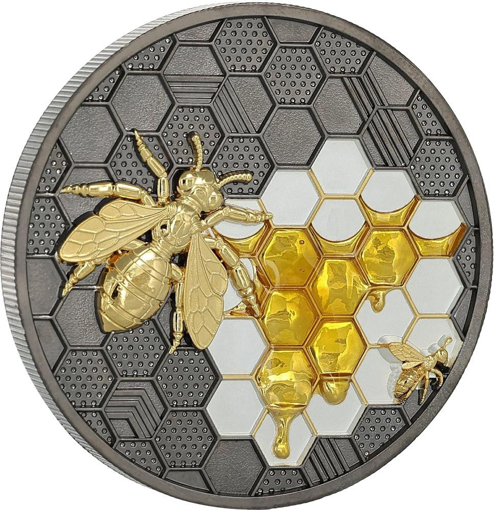 Decorative coin with gold bee and honeycomb design on a white background