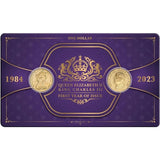 Purple packaging with gold coins and text for Queen Elizabeth II and King Charles III, 1984 and 2023.
