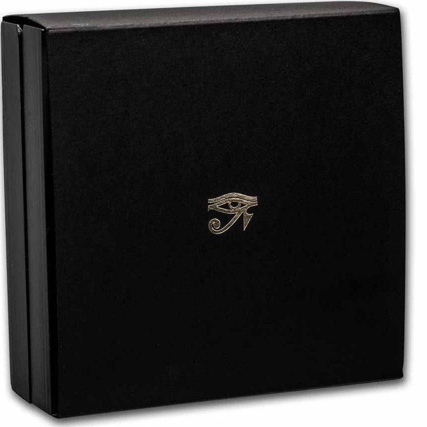 A product photograph of the protective outer sleeve made from thick matte black cardstock. The face of the sleeve features a clean, upscale minimalist aesthetic, highlighted by an ancient Egyptian Eye hieroglyph crisply stamped in reflective metallic gold foil right in the center. The bright gold artwork contrasts sharply against the solid dark background of the card.