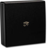 A product photograph of the protective outer sleeve made from thick matte black cardstock. The face of the sleeve features a clean, upscale minimalist aesthetic, highlighted by an ancient Egyptian Eye hieroglyph crisply stamped in reflective metallic gold foil right in the center. The bright gold artwork contrasts sharply against the solid dark background of the card.