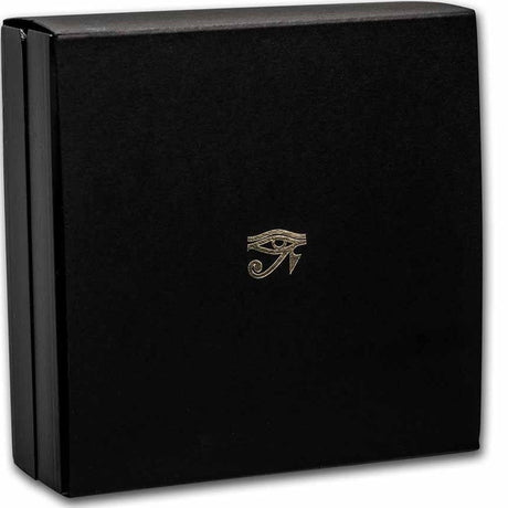 A product photograph of the protective outer sleeve made from thick matte black cardstock. The face of the sleeve features a clean, upscale minimalist aesthetic, highlighted by an ancient Egyptian Eye hieroglyph crisply stamped in reflective metallic gold foil right in the center. The bright gold artwork contrasts sharply against the solid dark background of the card.
