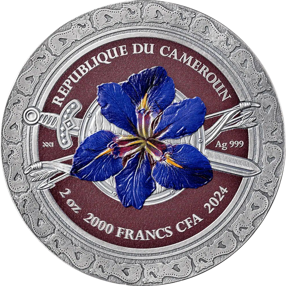 A circular commemorative coin for the Republic of the Cameroan 2000 Francs, featuring a detailed blue iris flower in the center, flanked by crossed swords on a dark red background with an ornate silver border.