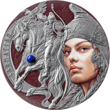 A circular silver-toned medallion or coin featuring a sculpted warrior on a horse with a winged motif, alongside a large stylized female face in profile. The design includes embossed details, engraved text along the left edge, and a small blue gemstone accent on the horse.