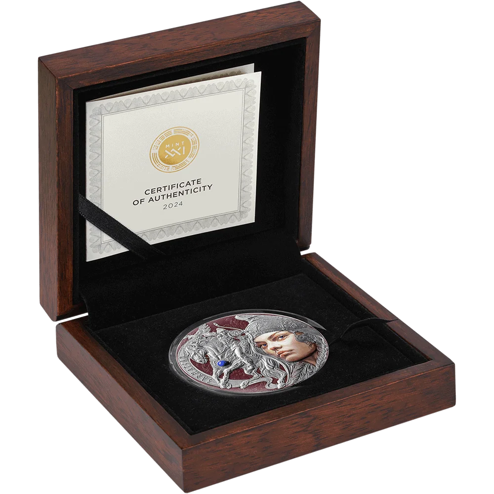 An open dark wood presentation box with a black velvet insert holding a round silver coin featuring a woman's face and a horse, alongside a Certificate of Authenticity card inside the lid.