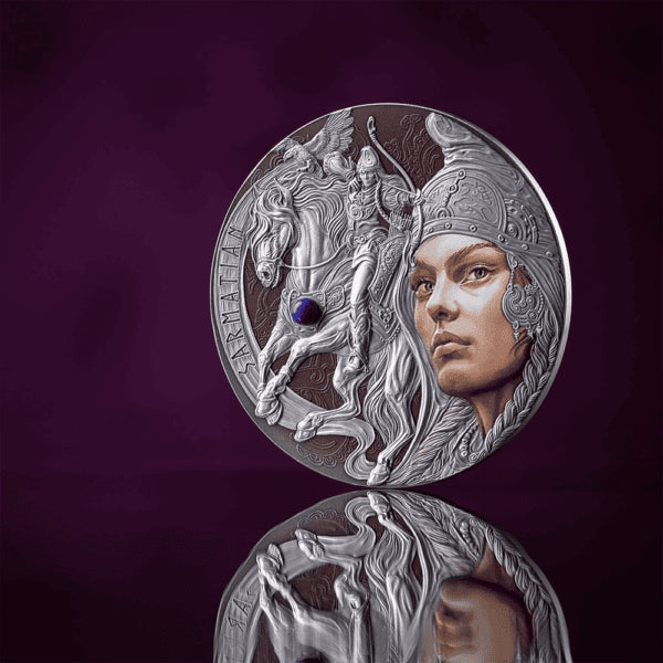 A round silver-toned coin or medallion featuring an embossed warrior on horseback and a woman's face, displayed on a reflective dark purple surface against a matching purple background.