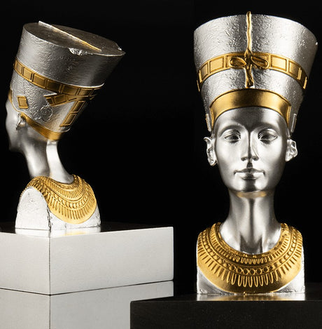 A 3D shaped silver coin with gold gilding, depicting the bust of Nefertiti. The coin is displayed on a stand against a black background.
