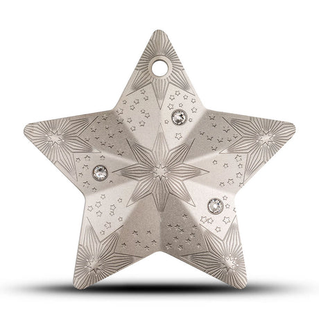 Decorative star-shaped object with intricate patterns and gemstones on a white background