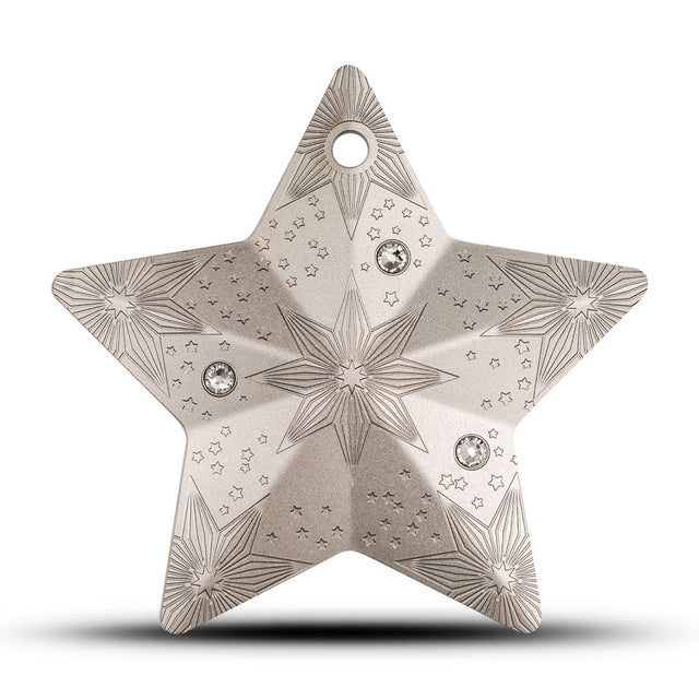 Decorative star-shaped object with intricate patterns and gemstones on a white background