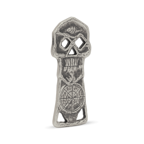 Decorative metal object with intricate designs on a white background