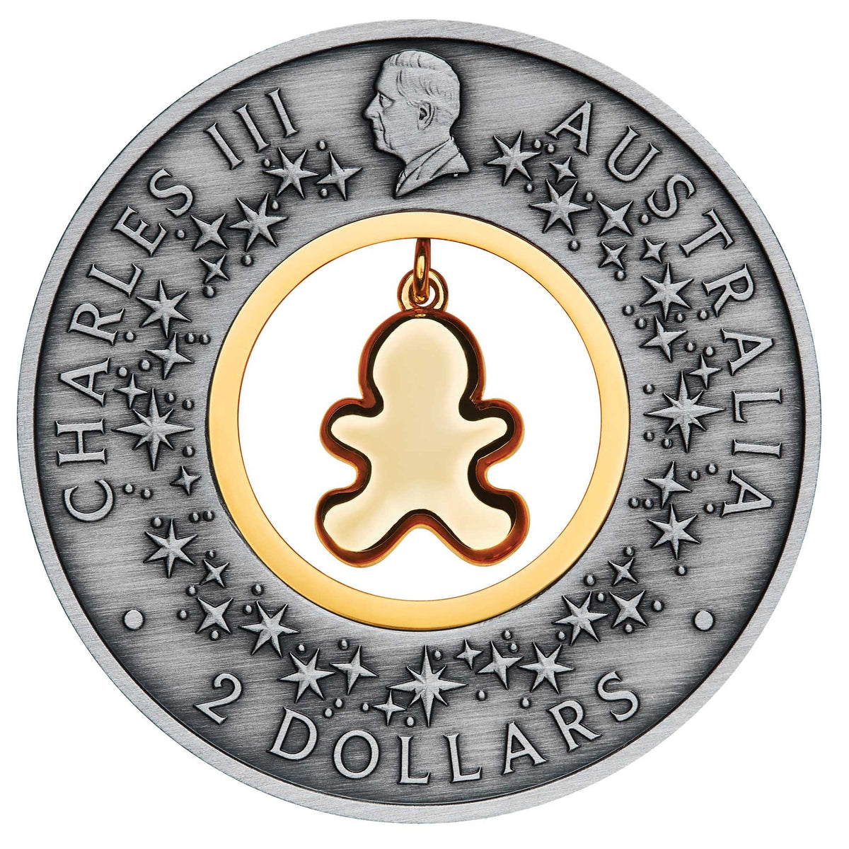 Obverse of the 2026 Gingerbread Christmas $2 silver coin, featuring King Charles III, decorative stars and the back of the dangling gingerbread insert.