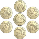 Set of gold coins with various designs on a white background