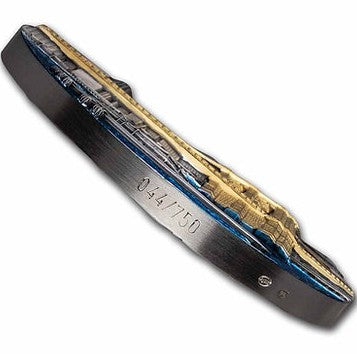 Folding knife with a detailed blade design on a white background