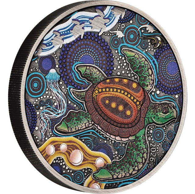 A round collectible coin featuring a detailed Aboriginal art design of a sea turtle, jellyfish, and waves, with the year 2026 inscribed on the side.