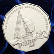 Reverse, new main image: Australia 2008 Australia II 50-cent coin showing the yacht under sail, winged-keel detail and 50 denomination on deep blue fabric.
