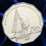 Reverse, new main image: Australia 2008 Australia II 50-cent coin showing the yacht under sail, winged-keel detail and 50 denomination on deep blue fabric.