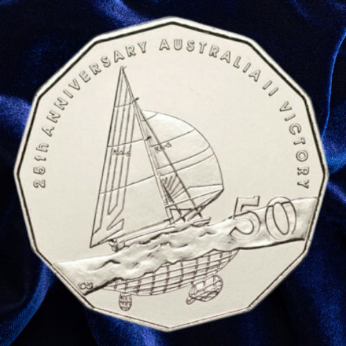 Reverse, new main image: Australia 2008 Australia II 50-cent coin showing the yacht under sail, winged-keel detail and 50 denomination on deep blue fabric.