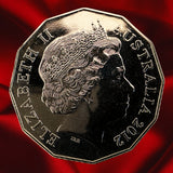 Obverse, dark reflection: Australia 2012 50-cent coin with Queen Elizabeth II portrait and inscriptions against a dark reflective field.