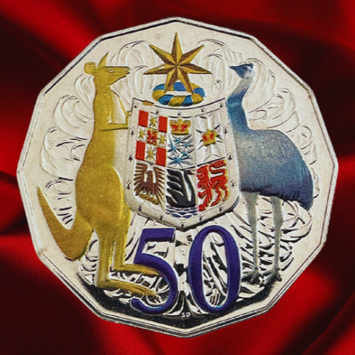 Reverse, reflective view: Coloured Australian Coat of Arms on the 2012 hyper-metallic 50-cent coin, photographed on red satin.