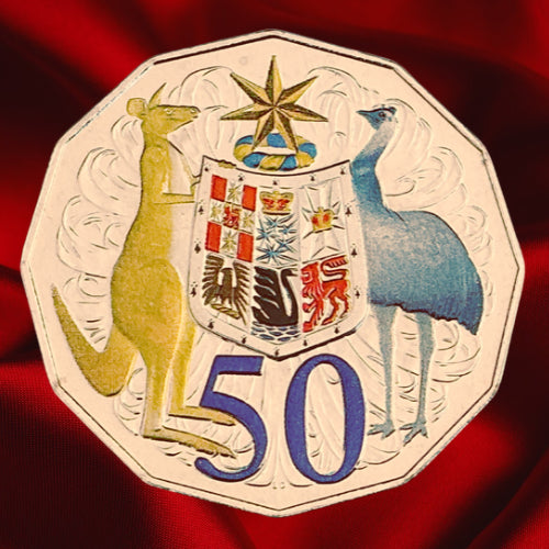 Reverse, warm-lit view: Australia 2012 hyper-metallic 50-cent coin with coloured Coat of Arms and purple 50 denomination under warm lighting.