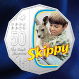 Reverse close-up: Australia 2020 Skippy coloured 50-cent coin showing Sonny Hammond holding Skippy within a television-shaped frame and the yellow Skippy logo.