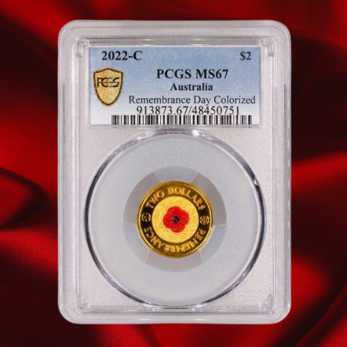 Reverse and grading label: Australia 2022-C $2 Remembrance Day red poppy coin in a PCGS MS67 holder, certification 48450751, on a red satin background.
