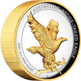 A gilded coin featuring an image of a wedge-tailed eagle with outstretched wings on a branch, alongside inscriptions and the Perth Mint's 'P' mintmark.