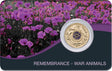 Front of the 2024 Remembrance War Animals coin pack, showing the purple poppy coin mounted on a card with a field of purple flowers.