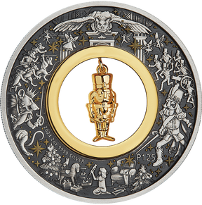 A silver coin with a Christmas-themed design featuring a gold-plated nutcracker figurine at its center, surrounded by stars and other festive imagery.