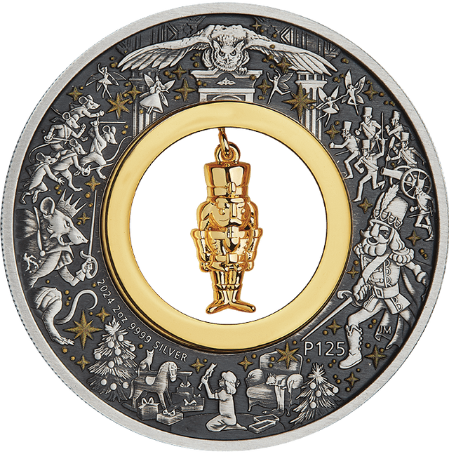 A silver coin with a Christmas-themed design featuring a gold-plated nutcracker figurine at its center, surrounded by stars and other festive imagery.