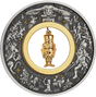 A silver coin with a Christmas-themed design featuring a gold-plated nutcracker figurine at its center, surrounded by stars and other festive imagery.