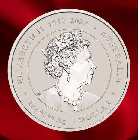 A round silver commemorative coin featuring a profile portrait of Queen Elizabeth II, with the text 'ELIZABETH II 1952-2022', 'AUSTRALIA', '1oz 9999 Ag', and '1 DOLLAR' around the edge, photographed against a rich red satin background.