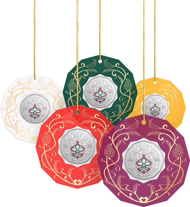 Decorative circular 50 cent coins  in ornament frame hanging  in various colors with intricate designs on a white background