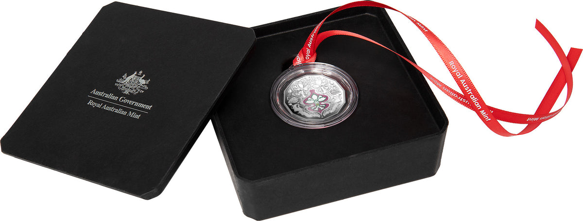 Silver coin with red ribbon in a black box, featuring the Australian Government logo.