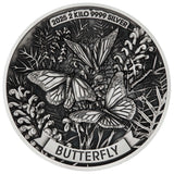 Silver butterfly coin with detailed design and text on a white background
