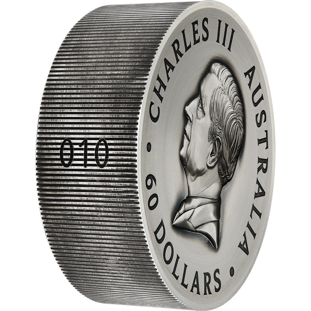 Silver coin with a portrait and text 'Charles III Australia 60 Dollars' on a white background Numbered Rim
