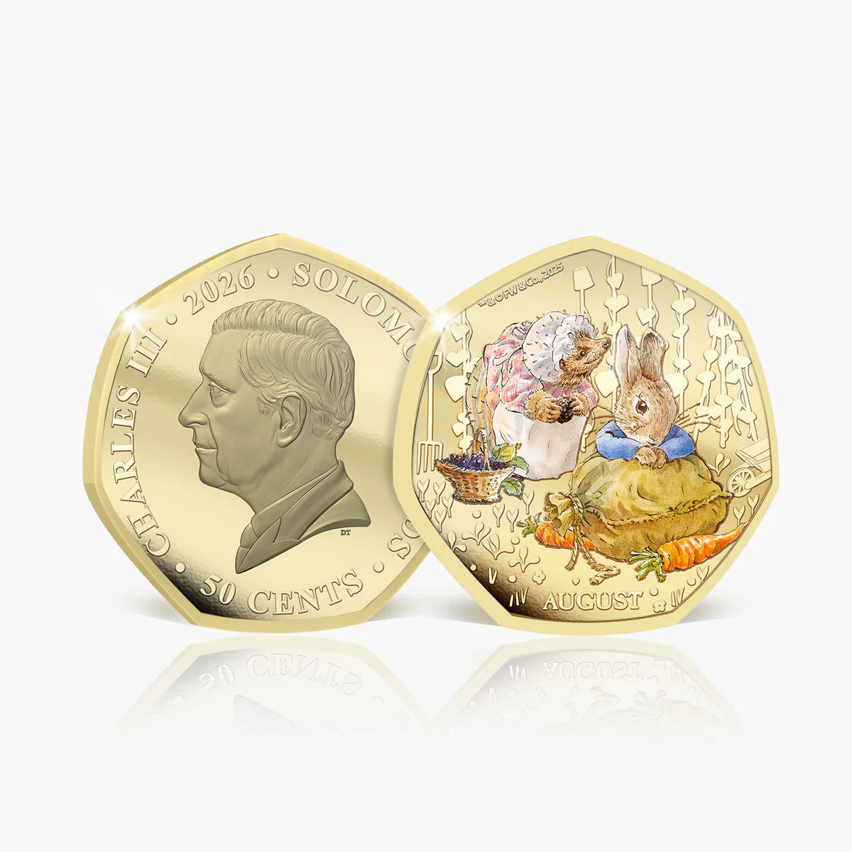 Two gold-colored 50 cents coin specimens from the Solomon Islands, dated 2026, displayed side by side on a light gray reflective surface. The left coin shows a profile portrait of Charles II with 'CHARLES II 2026 • SOLOMONS • 50 CENTS' inscribed.
