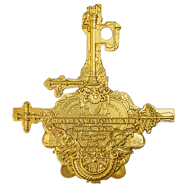 A gold-colored collectible coin with intricate embossed designs, including what appears to be a religious figure on a cross.