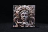 Decorative wall art with a snake and face design labeled 'Naga' on a black background
