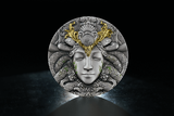 Decorative coin with an Indian God- Naga, face design qith gilding and 'INAGA' branding on a dark background