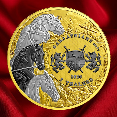 A round commemorative coin with a gold-toned outer ring and a detailed central design featuring horses, a shield, lions, and the text 'GARPATIAN'S MUT 2026 5 THEALERS', shown against a red satin fabric background.